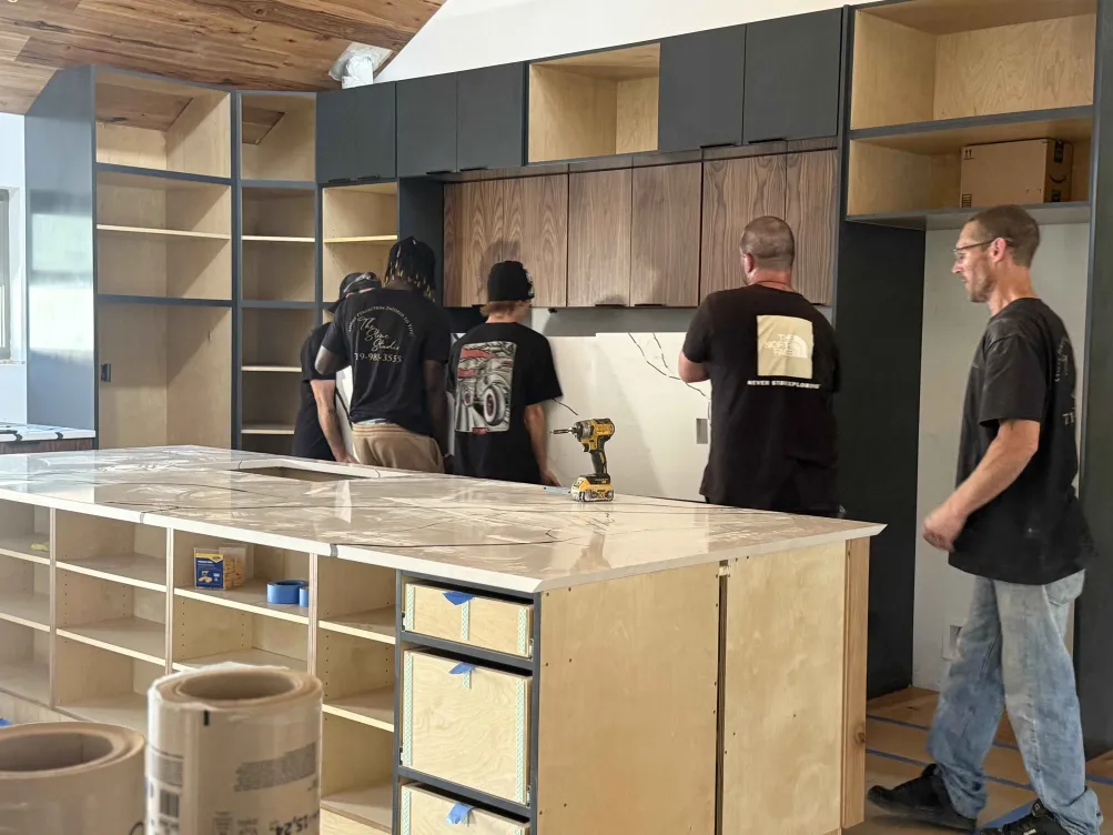Crew installing custom cabinetry